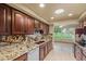 Beautiful kitchen featuring granite countertops, wood cabinets, and stainless steel appliances overlooking a nice yard view at 19053 N Lakeforest Dr, Sun City, AZ 85373