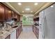 Bright kitchen featuring granite countertops, stainless steel appliances, and views of the backyard at 19053 N Lakeforest Dr, Sun City, AZ 85373