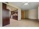 Open-concept space with tiled floors connecting the living area to the kitchen, fostering a seamless flow at 19053 N Lakeforest Dr, Sun City, AZ 85373