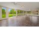 Sunroom with tiled floors and large windows offering a view of the landscaped backyard at 19053 N Lakeforest Dr, Sun City, AZ 85373