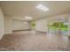 Bright and open living room features tiled flooring and expansive sliding glass doors to the backyard at 19053 N Lakeforest Dr, Sun City, AZ 85373