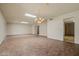The spacious living room showcases tiled flooring, seamlessly connecting to other areas of the home at 19053 N Lakeforest Dr, Sun City, AZ 85373