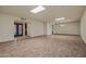 Bright living room featuring tiled flooring, with views into another area and entry at 19053 N Lakeforest Dr, Sun City, AZ 85373