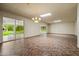 The expansive living room features tiled flooring and sliding glass doors that bring the outdoors in at 19053 N Lakeforest Dr, Sun City, AZ 85373