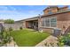 Expansive backyard featuring artificial turf, a covered patio, and well-maintained landscaping at 1906 N 140Th Dr, Goodyear, AZ 85395