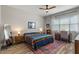 Cozy bedroom with a colorful blanket, a ceiling fan and natural light at 1906 N 140Th Dr, Goodyear, AZ 85395