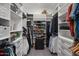 Walk-in closet featuring custom shelving and plentiful storage at 1906 N 140Th Dr, Goodyear, AZ 85395