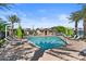 Beautiful community pool area featuring lounge chairs, umbrellas, and lush landscaping at 1906 N 140Th Dr, Goodyear, AZ 85395
