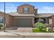 Charming two-story home showcasing a well-manicured lawn and a covered porch area at 1906 N 140Th Dr, Goodyear, AZ 85395