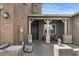 Inviting front porch with decorative stone accents, a charming porch, and cozy seating area at 1906 N 140Th Dr, Goodyear, AZ 85395