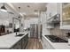 Bright kitchen with white cabinetry, a gas range, stainless steel appliances, and an island at 1906 N 140Th Dr, Goodyear, AZ 85395