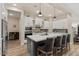 Modern kitchen featuring white cabinets, stainless steel appliances, and a gray island with seating at 1906 N 140Th Dr, Goodyear, AZ 85395