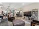 Open-concept living space featuring modern decor, a large screen TV, and comfortable seating at 1906 N 140Th Dr, Goodyear, AZ 85395