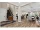 Spacious open-concept living area featuring hardwood floors, a staircase, and a combined living and dining space at 1906 N 140Th Dr, Goodyear, AZ 85395