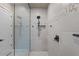 Modern shower with elegant tile work, matte black fixtures and a glass door at 1906 N 140Th Dr, Goodyear, AZ 85395