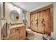 Cozy bathroom with light-colored vanity and novelty shower curtain at 19215 N Concho Cir, Sun City, AZ 85373