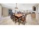 Bright dining room with a large table, seating for eight, and open kitchen at 19215 N Concho Cir, Sun City, AZ 85373