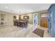 Traditional dining room with a wooden table, chairs, travertine tile flooring and access to the backyard at 19215 N Concho Cir, Sun City, AZ 85373
