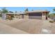 Charming home with a two-car garage, paver driveway, and desert landscaping at 19215 N Concho Cir, Sun City, AZ 85373