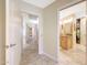 Hallway with tile flooring leading to bathroom and closet at 19215 N Concho Cir, Sun City, AZ 85373