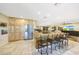 Open kitchen with granite countertops, stainless steel appliances, and breakfast bar with seating at 19215 N Concho Cir, Sun City, AZ 85373