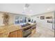 Well-equipped kitchen featuring an electric cooktop, built-in oven, granite countertops and an island at 19215 N Concho Cir, Sun City, AZ 85373
