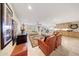 Expansive living room featuring tile floors, neutral colors, fireplace, and access to kitchen and exterior views at 19215 N Concho Cir, Sun City, AZ 85373