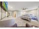 Spacious main bedroom features a large bed, a flat screen television and attached bathroom at 19215 N Concho Cir, Sun City, AZ 85373