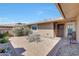 Cozy outdoor patio space with brick pavers, a table with chairs, and flowering plants at 19215 N Concho Cir, Sun City, AZ 85373