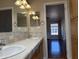 Bathroom with double sinks and wood cabinets leads into the home's living area at 201 S Greenfield S Rd # 222, Mesa, AZ 85206