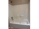 A white bathtub and white-tiled wall at 201 S Greenfield S Rd # 222, Mesa, AZ 85206