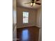 Cozy bedroom features hardwood floors, ceiling fan, and a bright window with neighborhood views at 201 S Greenfield S Rd # 222, Mesa, AZ 85206