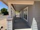 Extended covered porch with wooden deck, offers relaxing outdoor space and views of a well-maintained street at 201 S Greenfield S Rd # 222, Mesa, AZ 85206