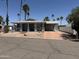 Charming single-story home with well-maintained landscaping and an attached carport on a sunny day at 201 S Greenfield S Rd # 222, Mesa, AZ 85206