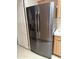 Close-up of a sleek, black stainless steel refrigerator, complementing the wooden cabinets at 201 S Greenfield S Rd # 222, Mesa, AZ 85206