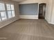 Cozy living room with neutral carpet, large screen, and bright windows, perfect for relaxation at 201 S Greenfield S Rd # 222, Mesa, AZ 85206