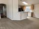 Open living space features a breakfast bar connecting to the kitchen with modern appliances and a skylight at 201 S Greenfield S Rd # 222, Mesa, AZ 85206