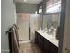 Bathroom with double sinks and modern fixtures, adjacent to a walk-in shower, and a towel bar at 20376 N Coronado Way, Surprise, AZ 85374