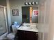 Bright bathroom features a vanity sink, large mirror, and a shower-tub combination at 20376 N Coronado Way, Surprise, AZ 85374