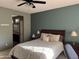 Comfortable bedroom featuring a large bed, side tables, and access to an ensuite bathroom at 20376 N Coronado Way, Surprise, AZ 85374