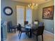 Bright dining room featuring a glass table, modern chairs, and natural light streaming through the window shutters at 20376 N Coronado Way, Surprise, AZ 85374