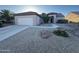 Charming single-story home featuring a two-car garage and low maintenance desert landscaping in front yard at 20376 N Coronado Way, Surprise, AZ 85374