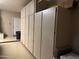 Garage featuring wall-to-wall cabinet storage, painted flooring and access door at 20376 N Coronado Way, Surprise, AZ 85374