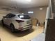 Spacious garage with painted floor, housing a silver SUV and offering ample storage space at 20376 N Coronado Way, Surprise, AZ 85374