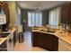Functional kitchen with modern appliances, brown cabinets, and a convenient sink area at 20376 N Coronado Way, Surprise, AZ 85374