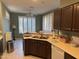 Well-lit kitchen with modern appliances, wooden cabinets, and a view of the adjacent dining area at 20376 N Coronado Way, Surprise, AZ 85374