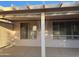 Covered patio area featuring a concrete floor, stucco walls, and windows with shutters for privacy at 20376 N Coronado Way, Surprise, AZ 85374