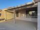 View of the covered patio, showcasing its concrete flooring, stucco walls, and shaded structure at 20376 N Coronado Way, Surprise, AZ 85374