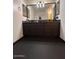 Bathroom showcasing double sinks in a dark vanity with matching mirrors and lighting at 21570 N Greenway Rd, Maricopa, AZ 85138