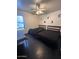 A bedroom with two beds with black bedding next to a sunny window at 21570 N Greenway Rd, Maricopa, AZ 85138